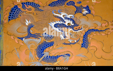 Representation of a azure dragon painted in traditional Bhutanese style on a wall in Wangdichholing Dzong. Stock Photo