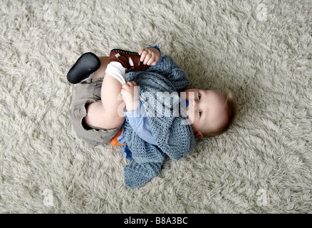 Baby boy lying on rug with blanket and dummy (with signed model release - available for commercial use) Stock Photo