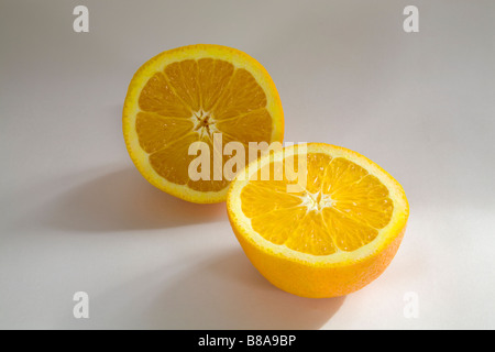 STILL LIFE FRUIT VEGETABLE Two halves of a navel orange sliced evenly Stock Photo