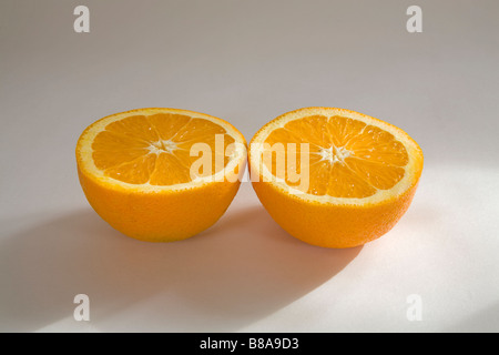 STILL LIFE FRUIT VEGETABLE Two halves of a navel orange sliced evenly Stock Photo