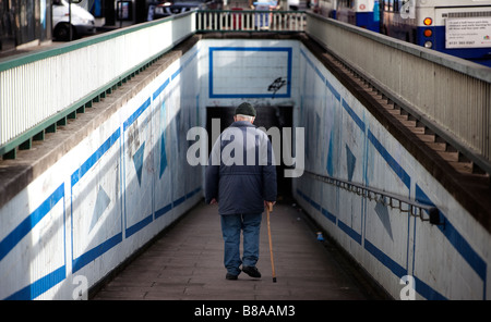 An elderly man walks down through a subway Birmingham England UK Stock Photo