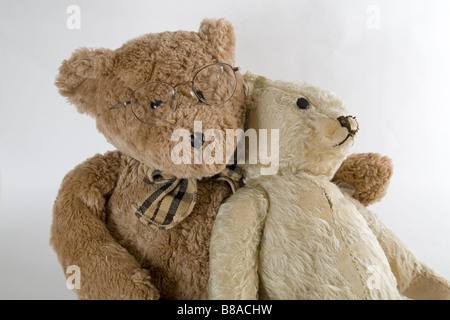 Two old teddy bears get together for Old Times Sake and to talk about their rips and tears Stock Photo
