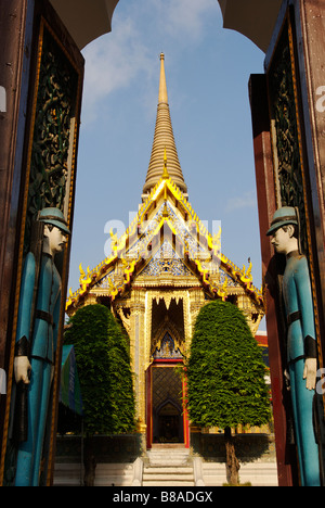 Wooden relief carving of soldiers on entrance door Wat Ratchabophit temple in central Bangkok Thailand Stock Photo