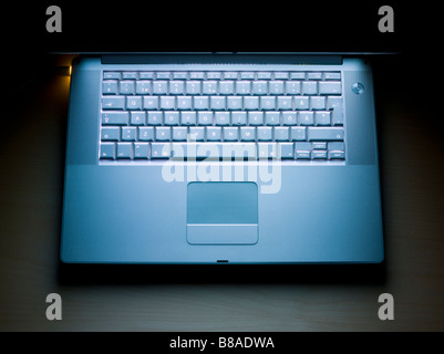 Notebook computer lit by its own screen Stock Photo