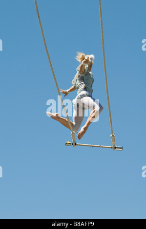 Trapeze artist lets go of the swing Stock Photo