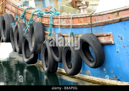 Detail of tyres hanging from a fishing boat. Stock Photo