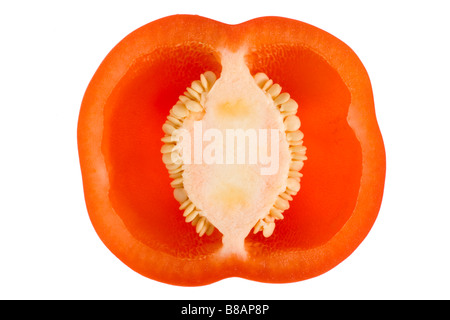 Cutout of a red pepper cut in half on its shortest side exposing the white placenta and seeds. Stock Photo