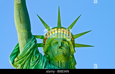 Staue of Liberty at dusk frontal view Lit up Stock Photo
