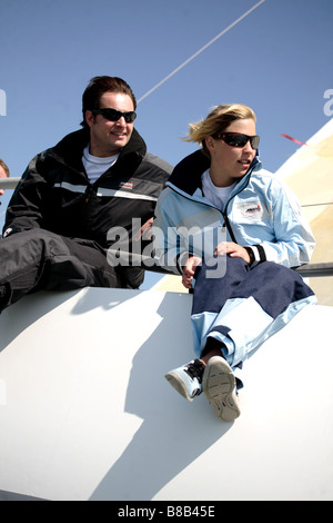 Man and woman sailing a yacht,the image is a color portrait action shot. Stock Photo