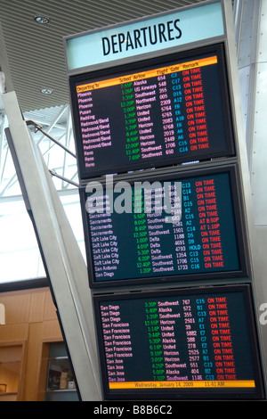 Airline departure notice board at the Portland International Airport in Portland Oregon USA Stock Photo