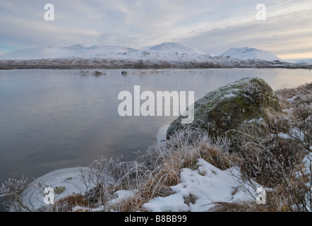 Looking across frozen Loch Ba to the snow covered Munro of Beinn a Chreachain Rannoch Moor Lochaber Scotland December