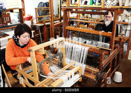 Traditional wooden hand weaving machines next to each other in a small ...