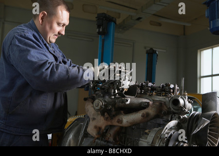 Mechanic Working on Motor Stock Photo