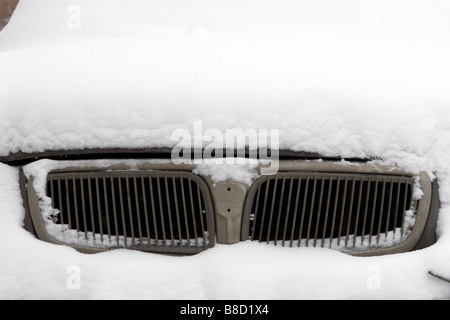 View of dirty chrome car air intake covered with snow. Stock Photo