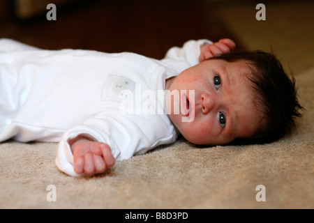 A newborn baby lying on it s back Stock Photo