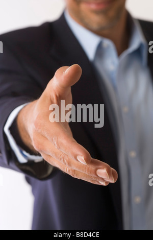 Businessman extending his hand in greeting Stock Photo