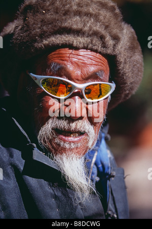 Chinese old man with modern sunglasses, Lijiang, Yunnan Province, China Stock Photo