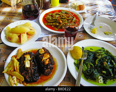 Greek Cuisine Fresh Eggplants in Tomato sauce Green Beans and Vleeta Stamnagathi Wild Greens Stock Photo