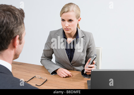 Businesswoman with remote control Stock Photo