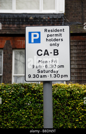 Resident permit holders only parking sign outside UK house Stock Photo