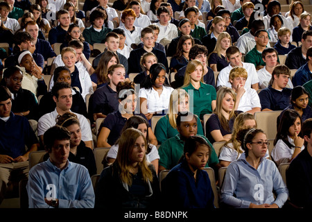 High school and middle school students seated in an auditorium. Stock Photo