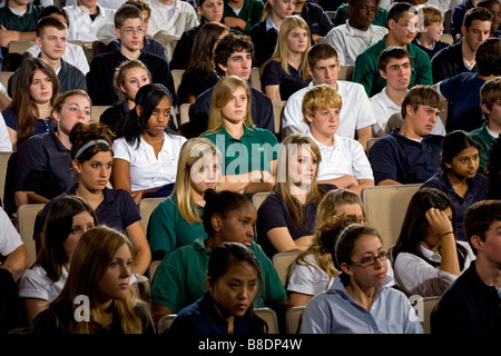 High school and middle school students seated in an auditorium. Stock Photo