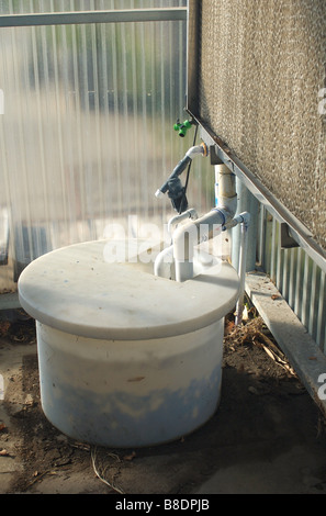 A water pump used to help cool down the temperature of a greenhouse Stock Photo