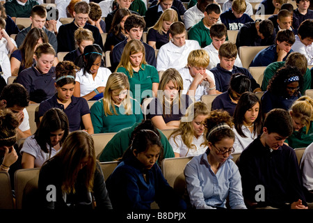 High school and middle school students seated in an auditorium. Stock Photo