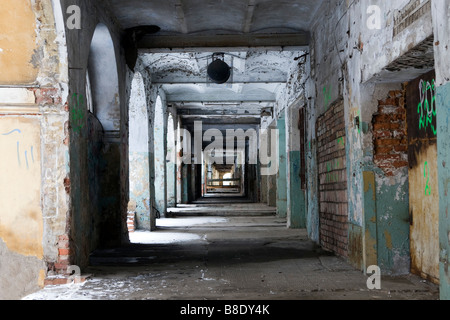 Old dirty abandoned gallery perspective partly covered with snow. Stock Photo