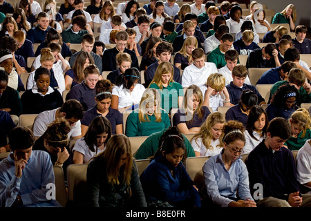 High school and middle school students seated in an auditorium. Stock Photo