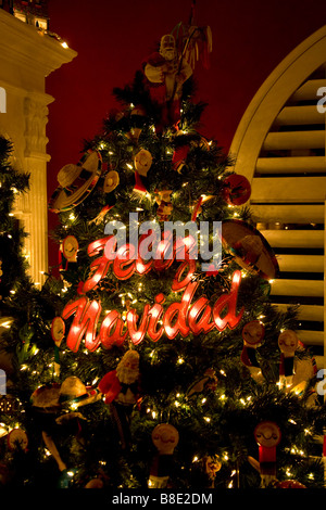 Feliz Navidad Sign on Christmas Tree Decorated with Sombreros Stock Photo