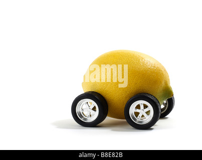 Studio shot of a lemon with automobile wheels Stock Photo