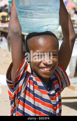 Senegalese Boy Carrying Water on His Head in St Louis in Senegal Africa Stock Photo