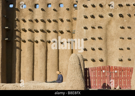 Workman at the Grande Mosquee in Djenne Mali in West Africa Stock Photo
