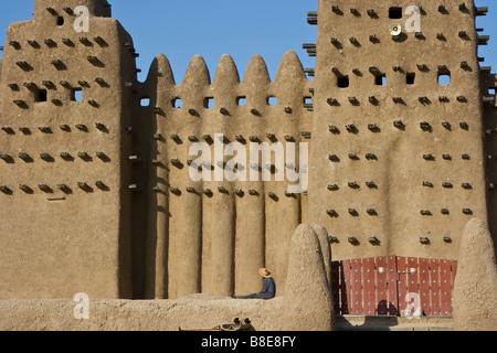 Workman at the Grande Mosquee in Djenne Mali in West Africa Stock Photo