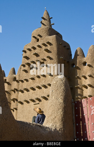 Workman at the Grande Mosquee in Djenne Mali in West Africa Stock Photo