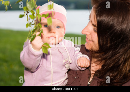 Mother 32 years old and her baby girl 9 months old outside Stock Photo