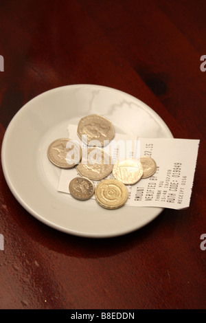 A tip left on a dish at a restaurant. Stock Photo