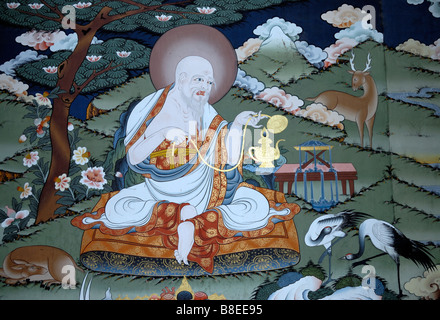 A painting in traditional Bhutanese style of a benevolent contemplative sage and symbols of longevity. Stock Photo