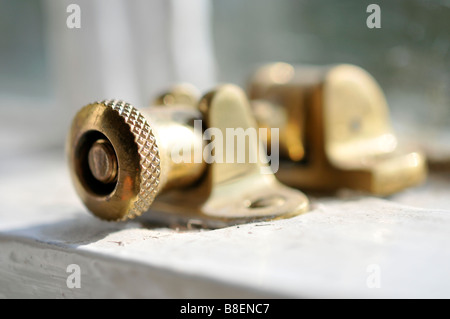window catch sash security brass fitting lock closing anti theft locking screw thumbwheell Stock Photo