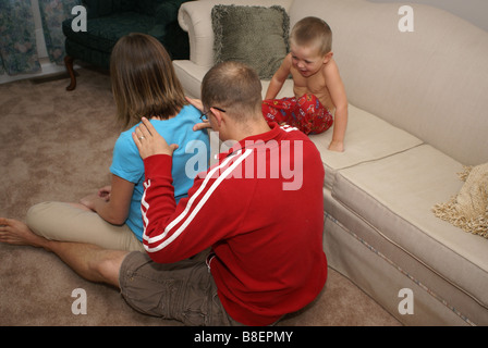 Watching Daddy Make Mommy Feel Better Stock Photo