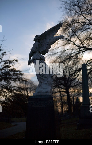 A beautiful statue of an angel at a cemetery Stock Photo