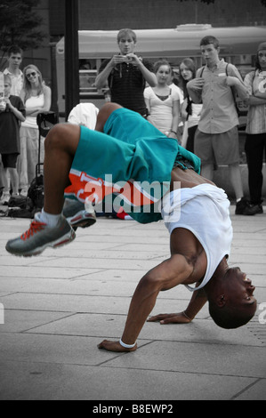 Street performer doing hand stand Stock Photo