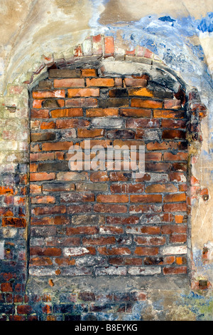 Old building window frame piled up with bricks. Stock Photo