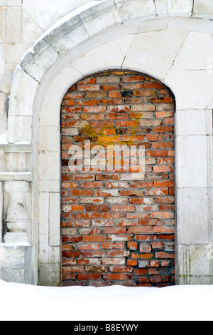 Old building door frame piled up with bricks. Stock Photo