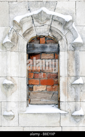Old building window frame piled up with bricks. Stock Photo