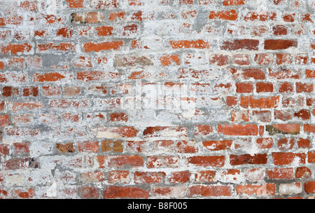 Brick building side wall partly coverd with stucco. Stock Photo