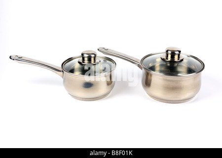 Two Stainless Steel Saucepans with glass lids against a white background Stock Photo