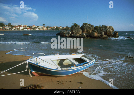 Traditional fishing boat moored on the main beach at Stoupa on the Mani peninsula, Peloponnese, mainland Greece Stock Photo