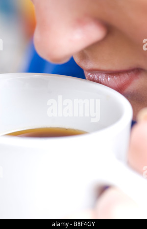 Close up of a woman drinking a hot beverage Stock Photo